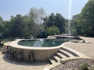 Custom concrete freeform swimming pool in Hiawatha, Iowa built by Splash Pool & Spa